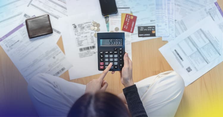 Woman with calculator and paperwork.