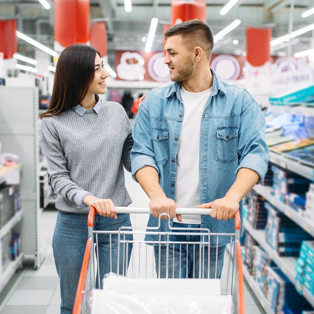 Two people shopping for electronics and household goods